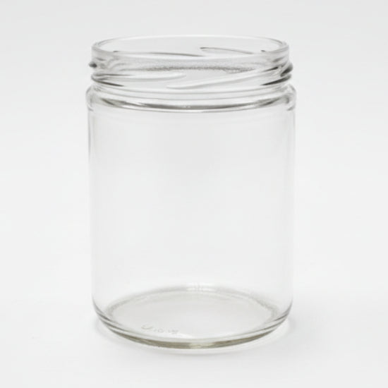 Clear glass jar on a white surface with a neutral background