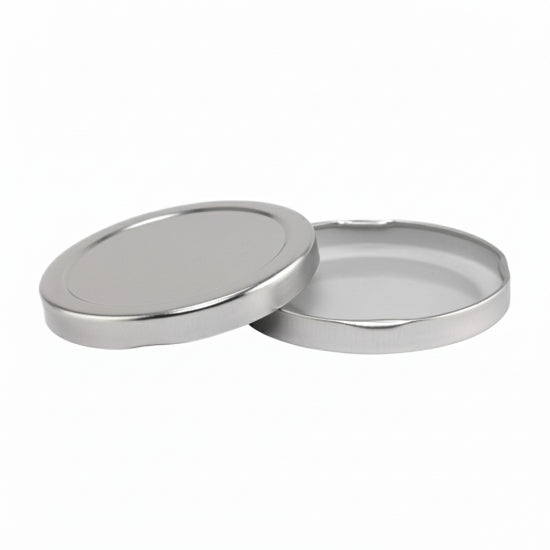 Two silver lids on a white background