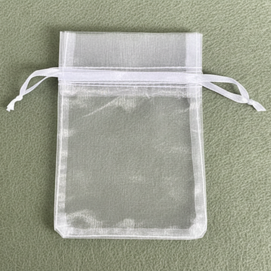 White organza drawstring bag on a green background
