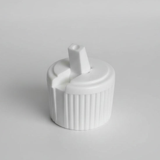 White plastic cap with a central cylindrical component on a white background