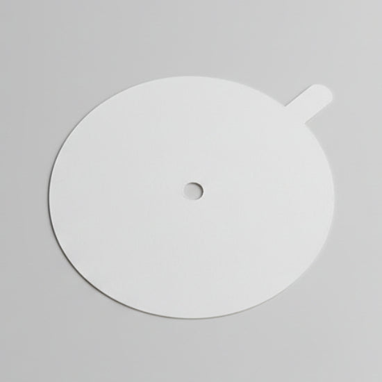 White circular object with a central hole on a gray background