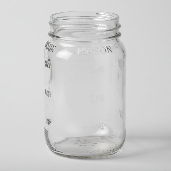 Clear glass mason jar on a white background