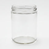 Clear glass jar on a white surface with a neutral background