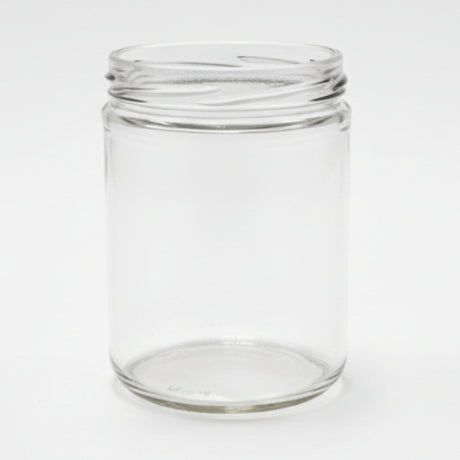 Clear glass jar on a white surface with a neutral background
