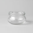 Clear glass jar on a grey background