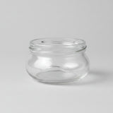 Clear glass jar on a grey background