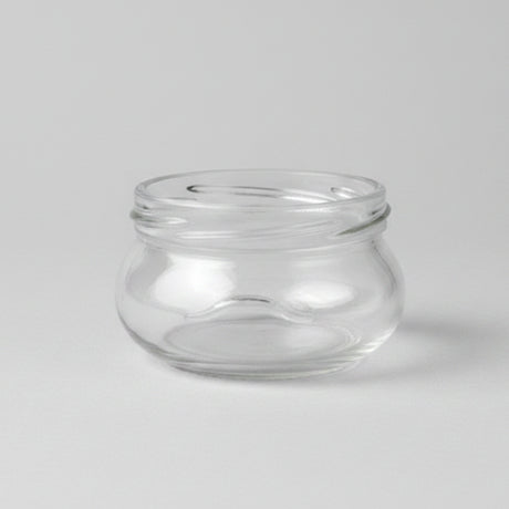 Clear glass jar on a grey background