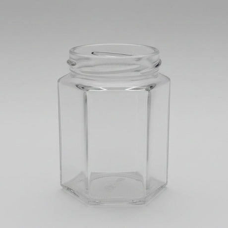 Clear glass hexagonal jar on a dark background