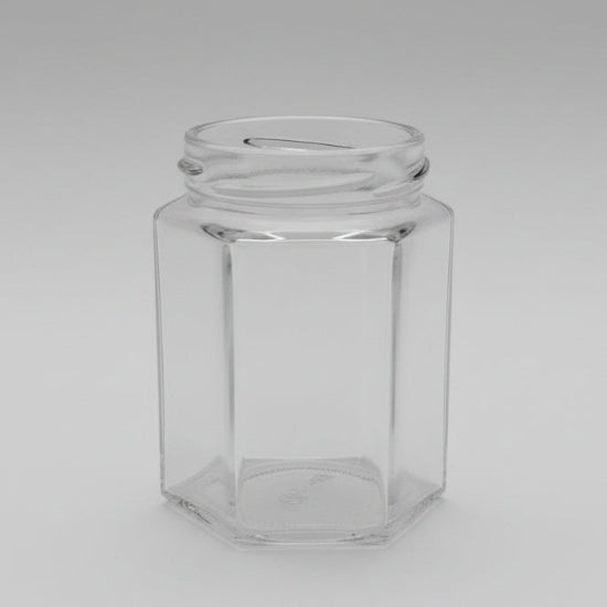 Clear glass hexagonal jar on a dark background