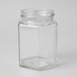 Clear glass hexagonal jar on a white background