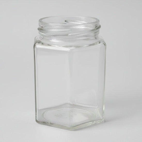 Clear glass hexagonal jar on a white background