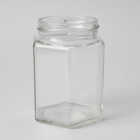 Clear glass hexagonal jar on a white background
