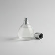 Perfume bottle with lavender and lemon on a wooden surface