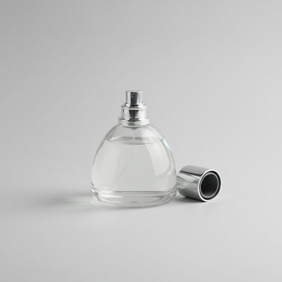 Perfume bottle with lavender and lemon on a wooden surface