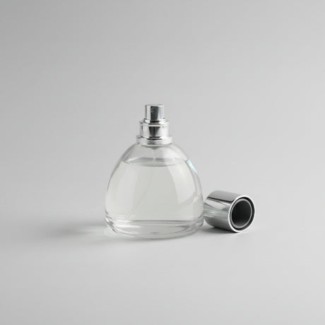 Perfume bottle with lavender and lemon on a wooden surface