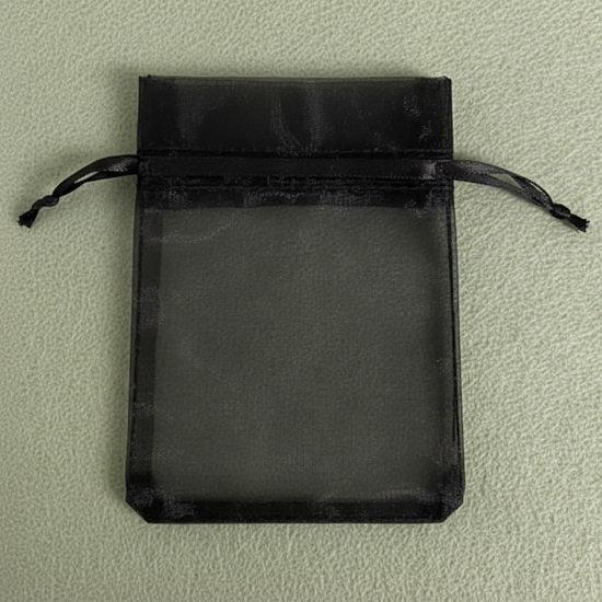 Black drawstring pouch on a light green background