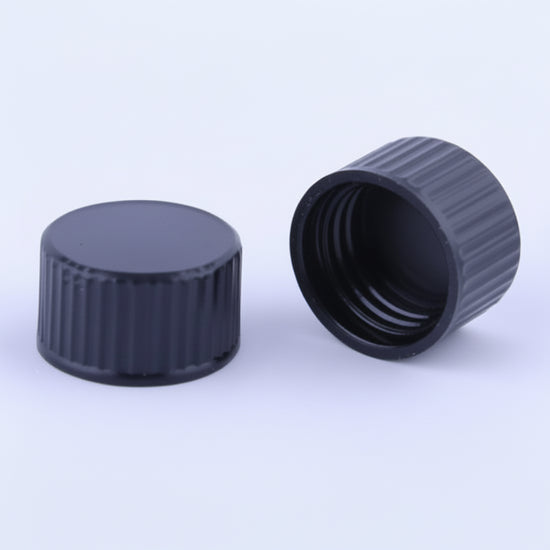 Two black plastic caps on a white background