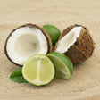 Coconut halves and limes on a sandy background