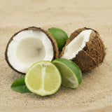 Coconut halves and limes on a sandy background