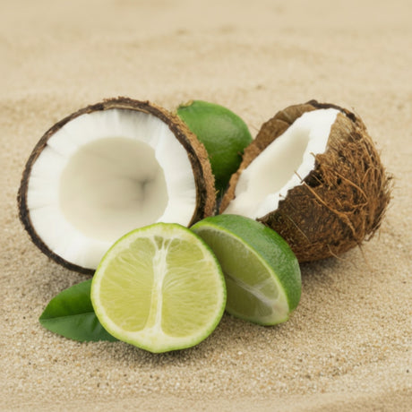Coconut halves and limes on a sandy background