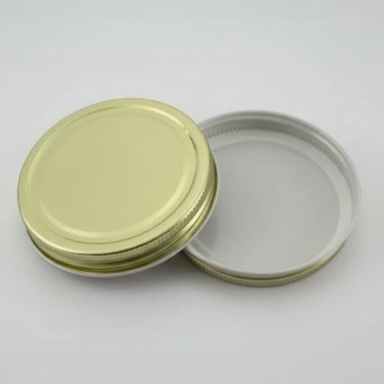 Gold metal lid a white background
