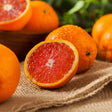 Oranges with a close-up of a halved orange revealing its juicy interior.
