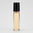Roll-on bottle with amber liquid and black cap on a white background