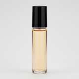 Roll-on bottle with amber liquid and black cap on a white background