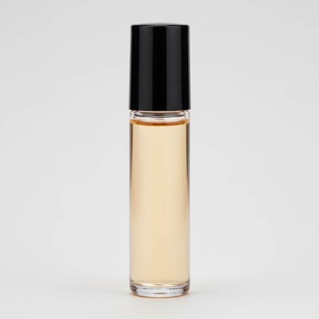 Roll-on bottle with amber liquid and black cap on a white background