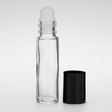 Clear glass roller bottle with a black cap on a white background