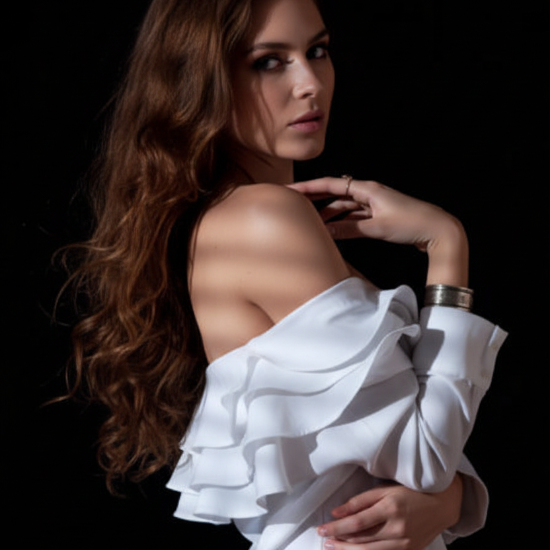 Woman wearing a white off-shoulder top against a black background