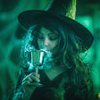 Person in witch costume holding a goblet with a green, mystical background