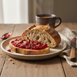 sourdough bread with a generous topping of cranberry marmalade. setting is a breakfast table. 