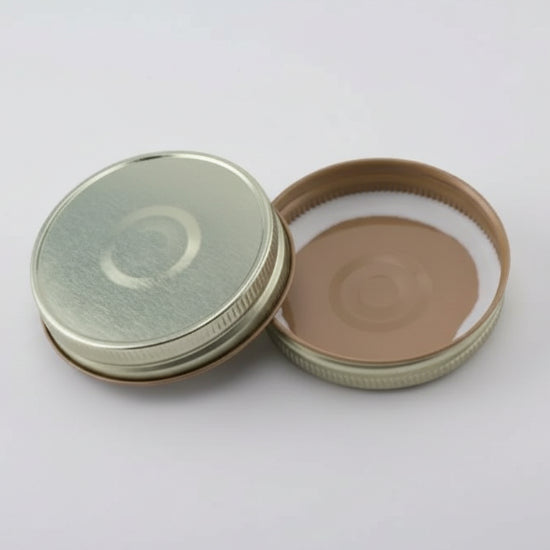 Gold button mason jar lids on a white background