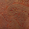 Close-up of brown leather with intricate paisley pattern