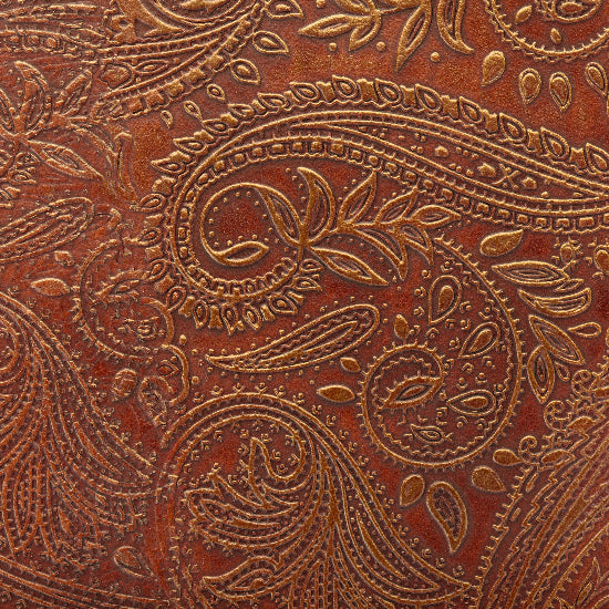 Close-up of brown leather with intricate paisley pattern