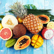 Assorted tropical fruits on a blue wooden surface