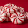 Red and white striped candies on a red background