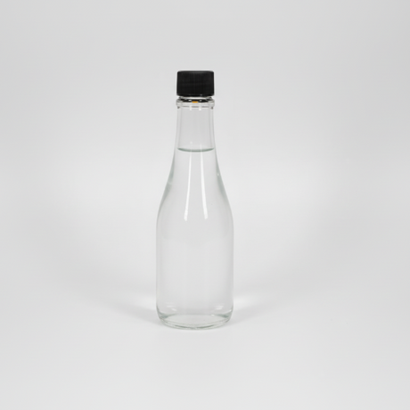 Clear glass bottle with a black cap on a white background