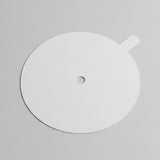 White circular object with a central hole on a gray background