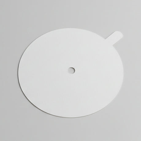 White circular object with a central hole on a gray background